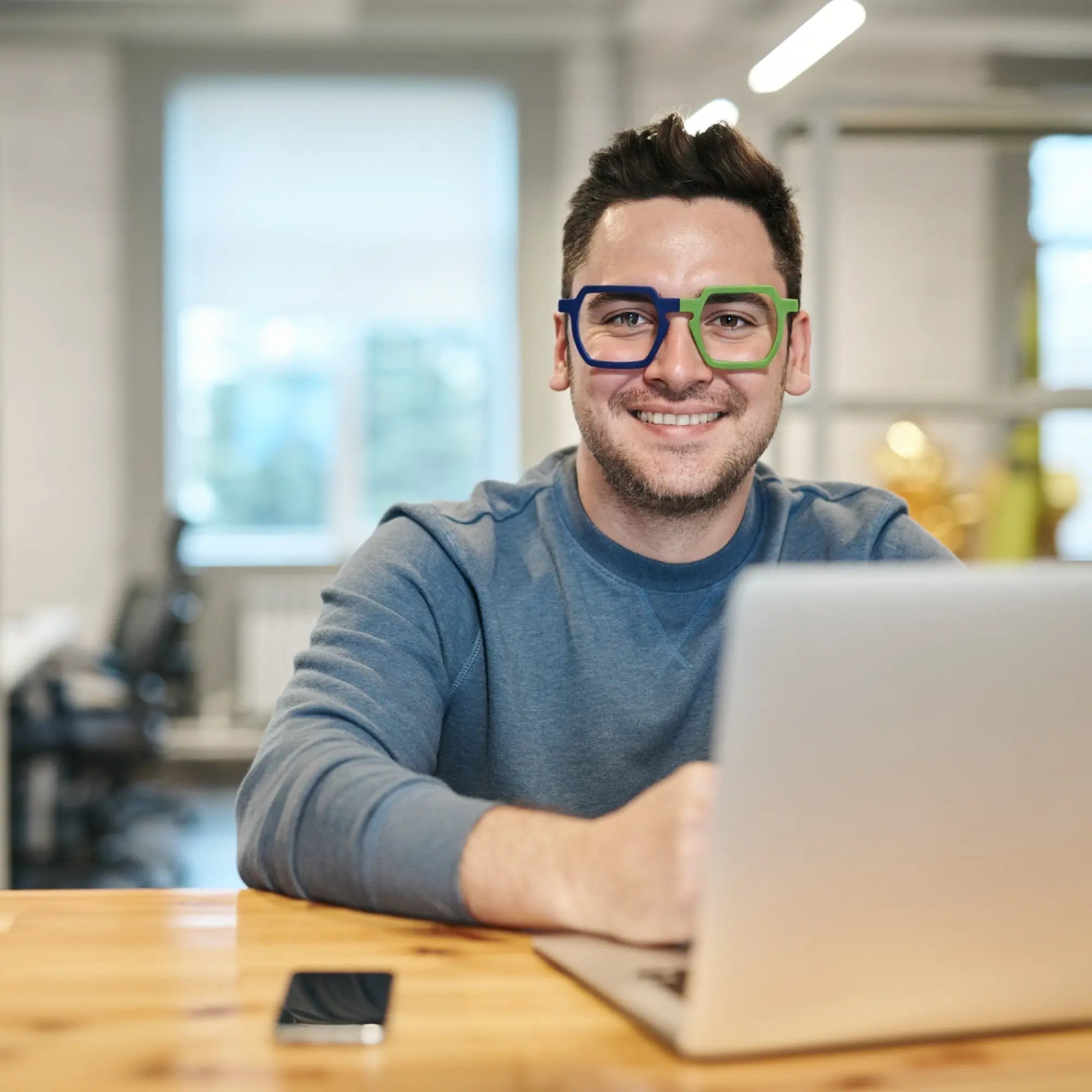 Model showcasing VoyueLens™ Blue-Green Matte eyeglasses in a clean, urban fashion setting